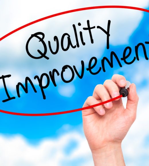 Man Hand writing Quality Improvement with black marker on visual screen. Isolated on background. Business, technology, internet concept. Stock Photo